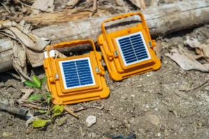 Kit solaire portable utilisé pour recharger un téléphone dans une cour urbaine en Guinée